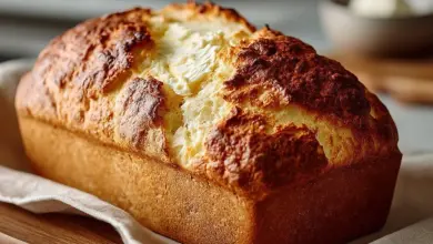 Loaf of fresh gluten-free bread with slices on a cutting board