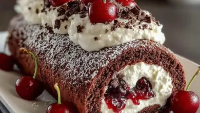 Delicious Black Forest Cream Roll Cake with chocolate, cream, and cherries