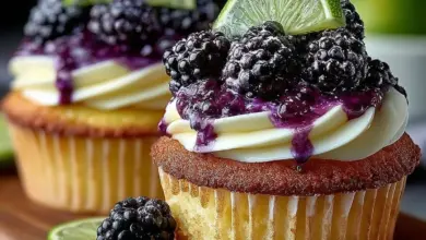 Blackberry lime cheesecake cupcakes topped with fresh blackberries and lime zest.
