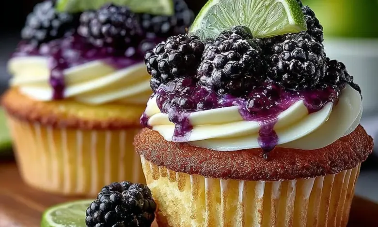 Blackberry lime cheesecake cupcakes topped with fresh blackberries and lime zest.