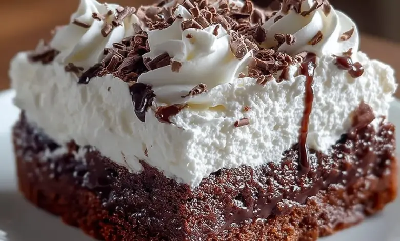 Delicious Brownie Refrigerator Cake layered with creamy frosting and topped with chocolate.