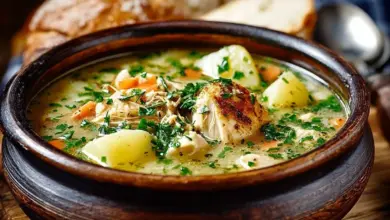 Bowl of creamy Chicken Potato Soup garnished with fresh herbs