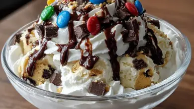 Delicious Chocolate Crunch Cookie Dough Sundae topped with cookie dough and chocolate crunch