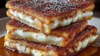 Delicious churro stuffed French toast dusted with cinnamon sugar on a plate