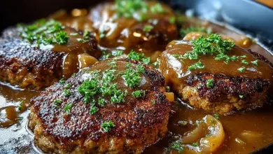 Plate of delicious Salisbury steak served with gravy and vegetables