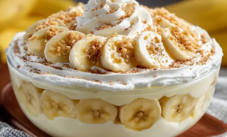 Delicious homemade easy banana pudding in a glass dish with whipped cream and bananas