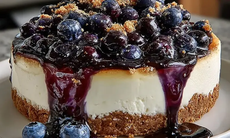 Fresh blueberry cheesecake topped with ripe blueberries and creamy layers.