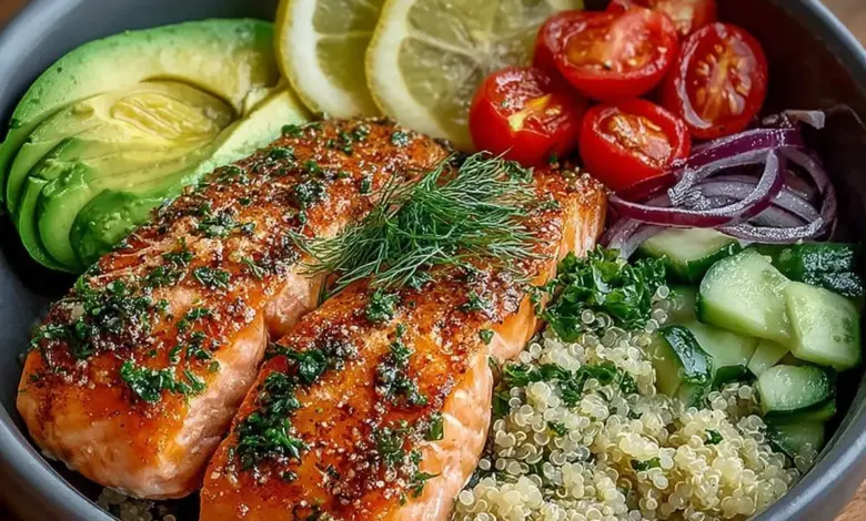 Lemon herb salmon served in a quinoa bowl with avocado and fresh herbs