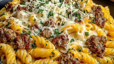 Delicious plate of Loaded Cheeseburger Alfredo Pasta topped with cheese and herbs