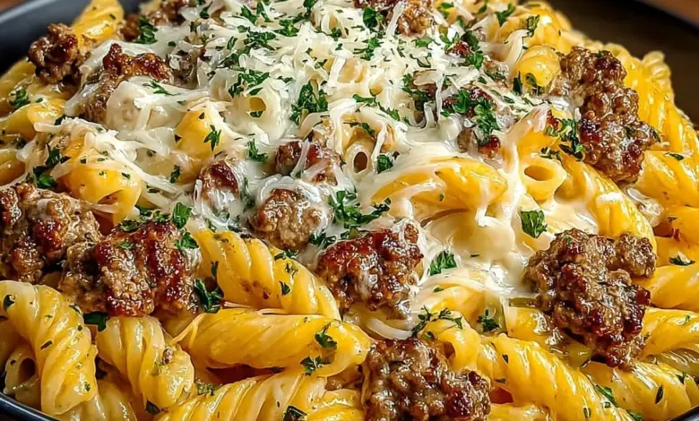 Delicious plate of Loaded Cheeseburger Alfredo Pasta topped with cheese and herbs