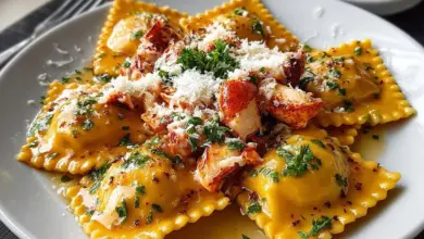 Plate of Lobster Ravioli garnished with herbs and sauce