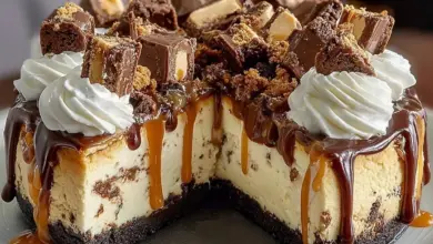 Delicious Reese's Peanut Butter Cup Cheesecake topped with chocolate and peanut butter.