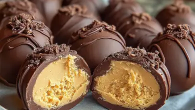 Delicious homemade peanut butter eggs on a white plate.