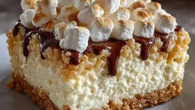 Delicious Rice Krispie Treat Cheesecake topped with crispy marshmallow layer