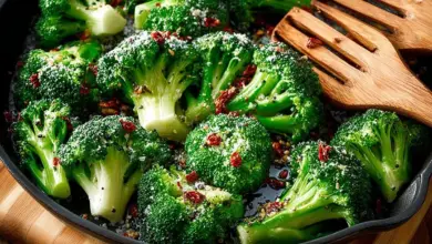 Plate of smashed broccoli with garlic and herbs, a healthy side dish.
