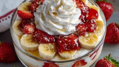 Delicious strawberry banana pudding served in a glass dish topped with fresh strawberries