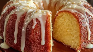 Vanilla buttermilk pound cake drizzled with cream cheese glaze on a plate