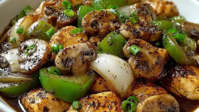 Plate of yummy black pepper chicken with mushrooms garnished with herbs