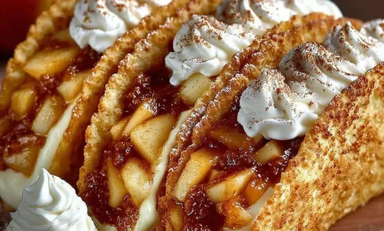 Delicious apple cheesecake tacos served on a plate with caramel drizzle.