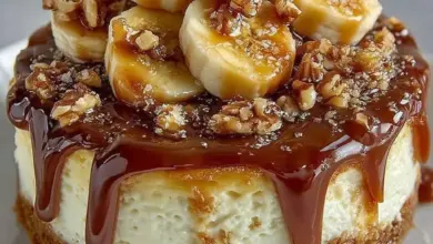 Delicious Banana Caramel Nut Cheesecake topped with nuts and caramel drizzle