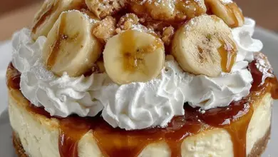 Delicious banana pudding cheesecake topped with banana slices and whipped cream.