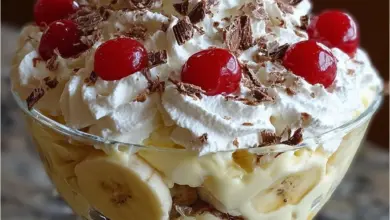 Delicious Banana Split Fluff dessert with layers of banana, whipped cream, and chocolate sauce.