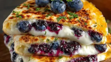 Blueberry breakfast quesadillas with melted cheese and fresh berries