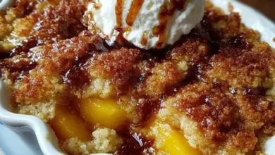 Buttery vanilla peach cobbler topped with a sweet golden crust and fresh peach slices