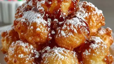 Delicious funnel cake bites served with powdered sugar and dip