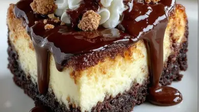 Delicious hot fudge sundae brownie cheesecake topped with ice cream and fudge sauce.