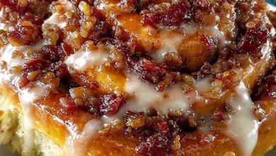 Deliciously drizzled Maple Bacon Cinnamon Rolls on a wooden table