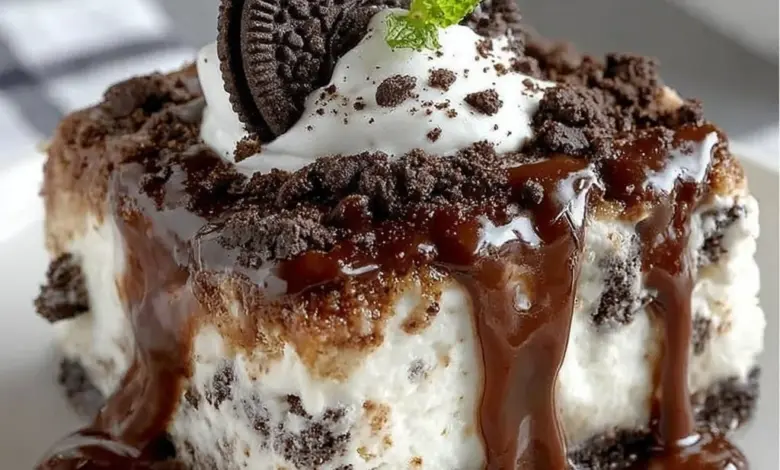 Slice of Oreo Ice Cream Cake Delight topped with chocolate and Oreo pieces
