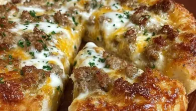 Sausage gravy breakfast pizza topped with cheese and herbs