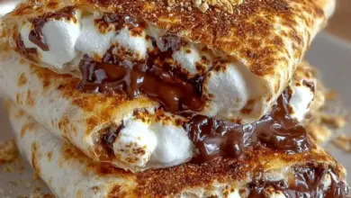 Delicious S'Mores Crunchwrap featuring chocolate, marshmallows, and graham crackers.