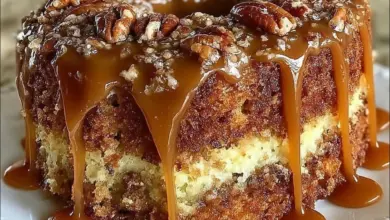 Delicious Southern Pecan Caramel Cake topped with caramel and pecans