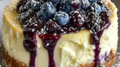 Delicious white chocolate blueberry cheesecake slice topped with fresh blueberries