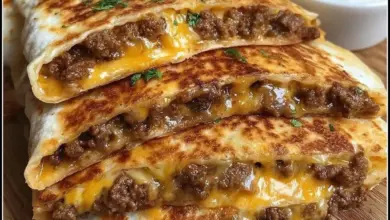Bacon cheeseburger quesadillas on a plate, garnished and ready to serve.