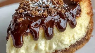 Delicious Boston Cream Pie Cheesecake topped with chocolate and cream