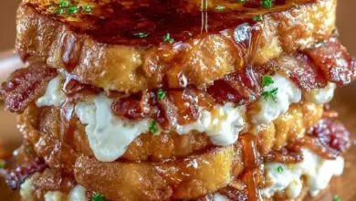 Bourbon Maple Bacon Stuffed French Toast served with syrup and fresh berries