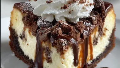 Delicious Brownie Sundae Cheesecake topped with chocolate syrup and cherries