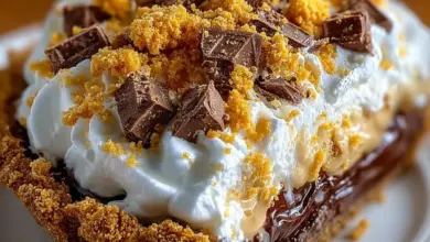 Delicious Butterfinger Pie topped with creamy peanut butter and chocolate