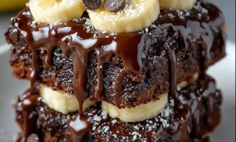 Delicious chocolate covered banana brownies topped with bananas and chocolate glaze.