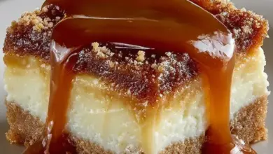 Creamy caramel cheesecake bars topped with a rich caramel drizzle.