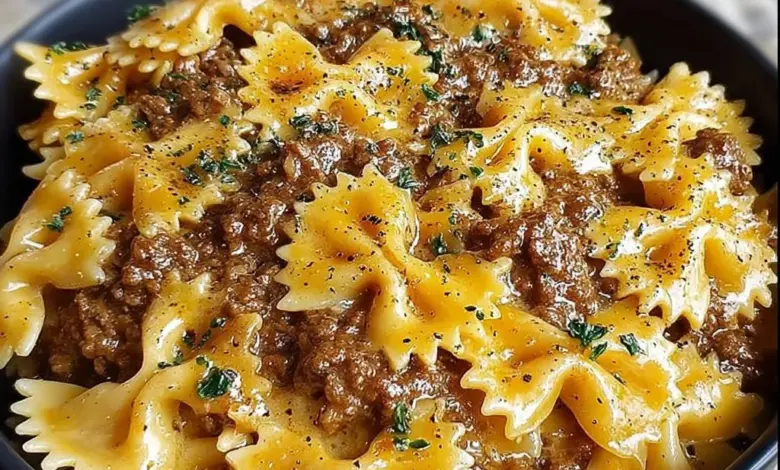 Plate of creamy Velveeta beef pasta with bowtie noodles garnished with herbs