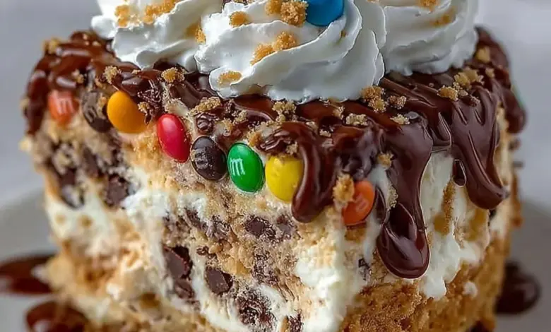 Decadent chocolate M&M’s and cookie dough ice cream cake on a decorative plate