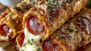 Delicious cheesy pepperoni pizza roll-ups on a serving plate