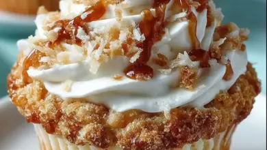 Delicious coconut cream pie cupcakes topped with creamy coconut frosting.