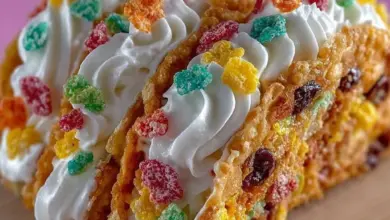 Fruity Pebbles cheesecake tacos displayed on a colorful plate.