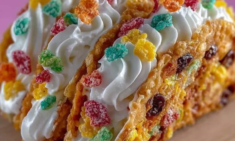 Fruity Pebbles cheesecake tacos displayed on a colorful plate.