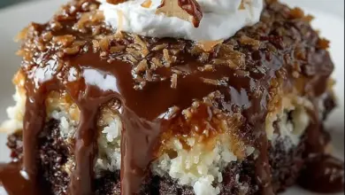 Delicious German Chocolate Poke Cake topped with coconut and pecan frosting